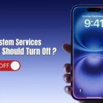 Hand holding an iPhone with the screen showing 9:41 AM, next to text saying “iPhone System Services: What You Should Turn Off?”