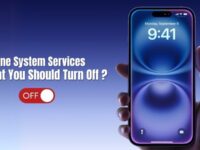 Hand holding an iPhone with the screen showing 9:41 AM, next to text saying “iPhone System Services: What You Should Turn Off?”