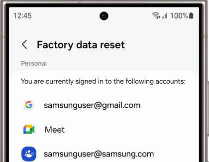 Samsung phone screen showing the “Factory data reset” page with signed-in Google and Samsung accounts listed for review.