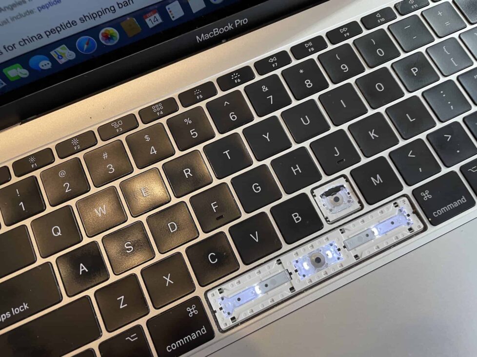MacBook Keyboard with Keys Removed for Replacement A MacBook keyboard with several keys removed, showing the underlying scissor-switch mechanism during a keyboard replacement process.