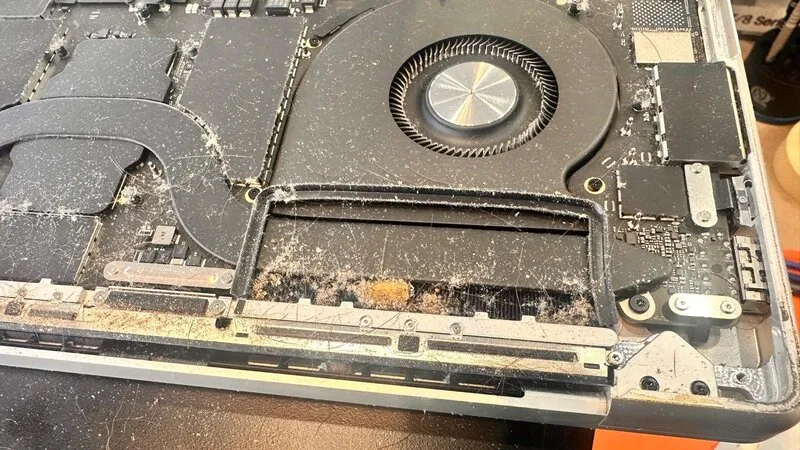 Dead MacBook Pro A2485 Motherboard Recovery Case Sudy 2 Close-up of MacBook Pro motherboard showing heavy dust buildup, corrosion near the USB-C controller, and signs of moisture damage.