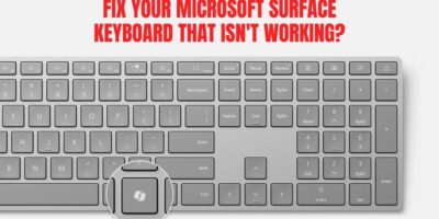 Grey Microsoft Surface keyboard with a highlighted key and bold red text reading “Fix Your Microsoft Surface Keyboard That Isn’t Working?”