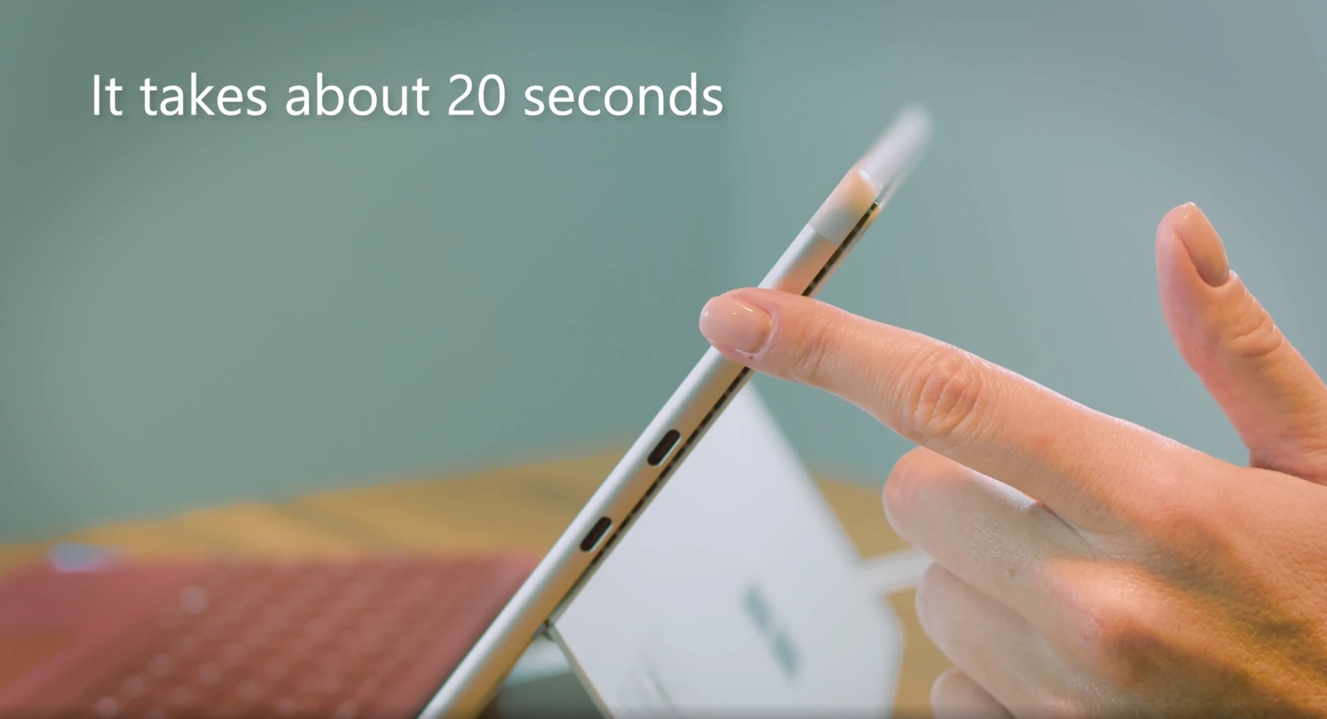 How To Fix Microsoft Surface Keyboard That Isn't Working? 2 Close-up of a person pressing the power button on a Microsoft Surface tablet, demonstrating the “Did You Try Turning It Off and On Again?” fix.