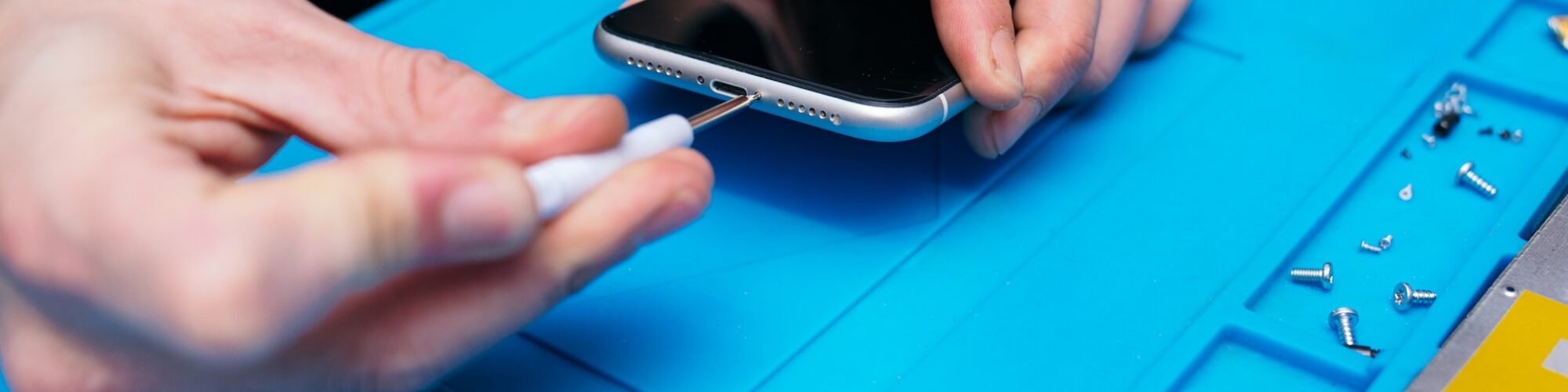 Professional Technician Repairing Smartphone with Precision Tools Professional Technician Repairing Smartphone with Precision Tools